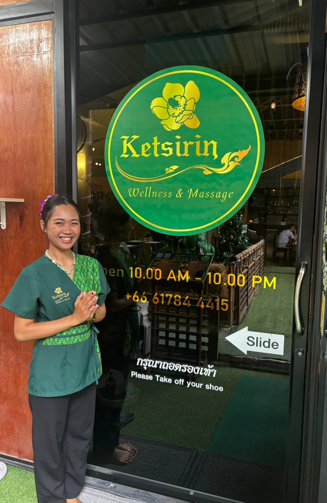 Professional staff at Ketsirin Bang Tao entrance showing traditional Thai greeting