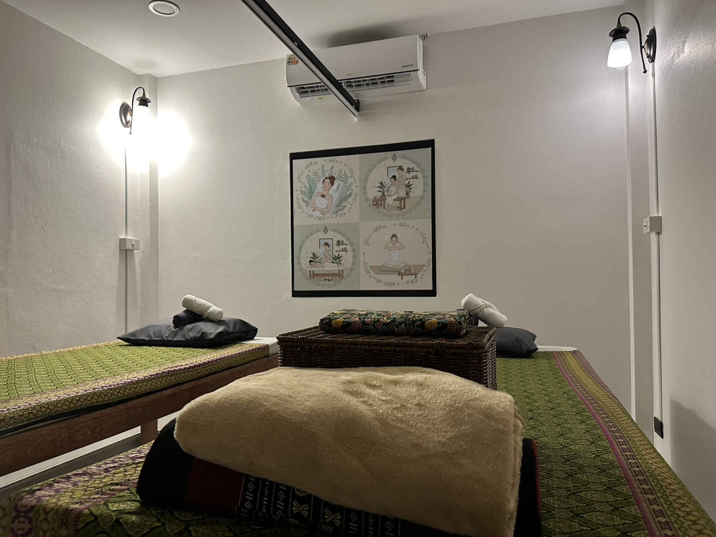 Cosy massage room at Ketsirin Cherngtalay with Thai massage beds, wall art and warm lighting